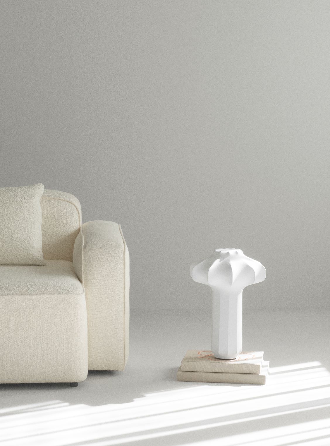 Weiße Phantom Table Lamp Tischleuchte von Normann Copenhagen auf Büchern neben Sofa.