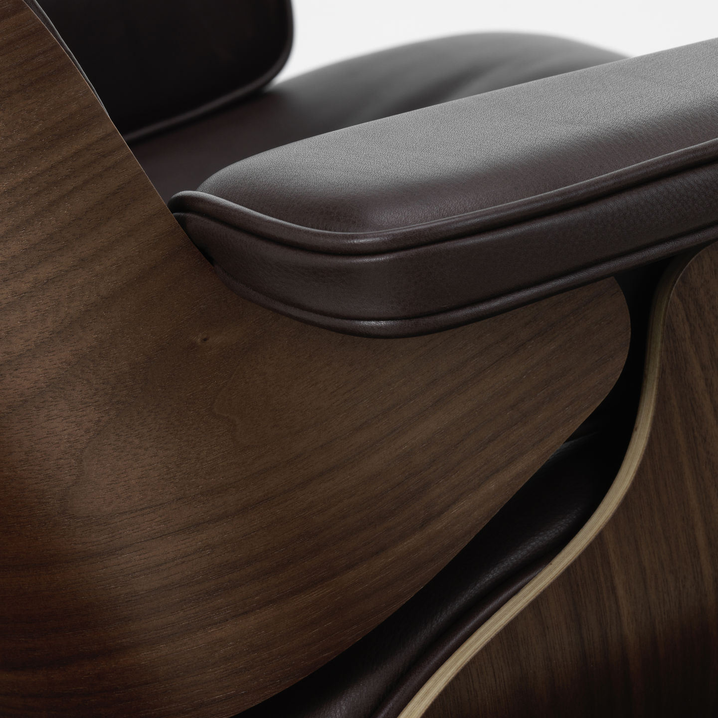 Detailaufnahme: Eames Lounge Chair Sessel mit braunem Leder und dunklem Holzfurnier, Designklassiker von Vitra.