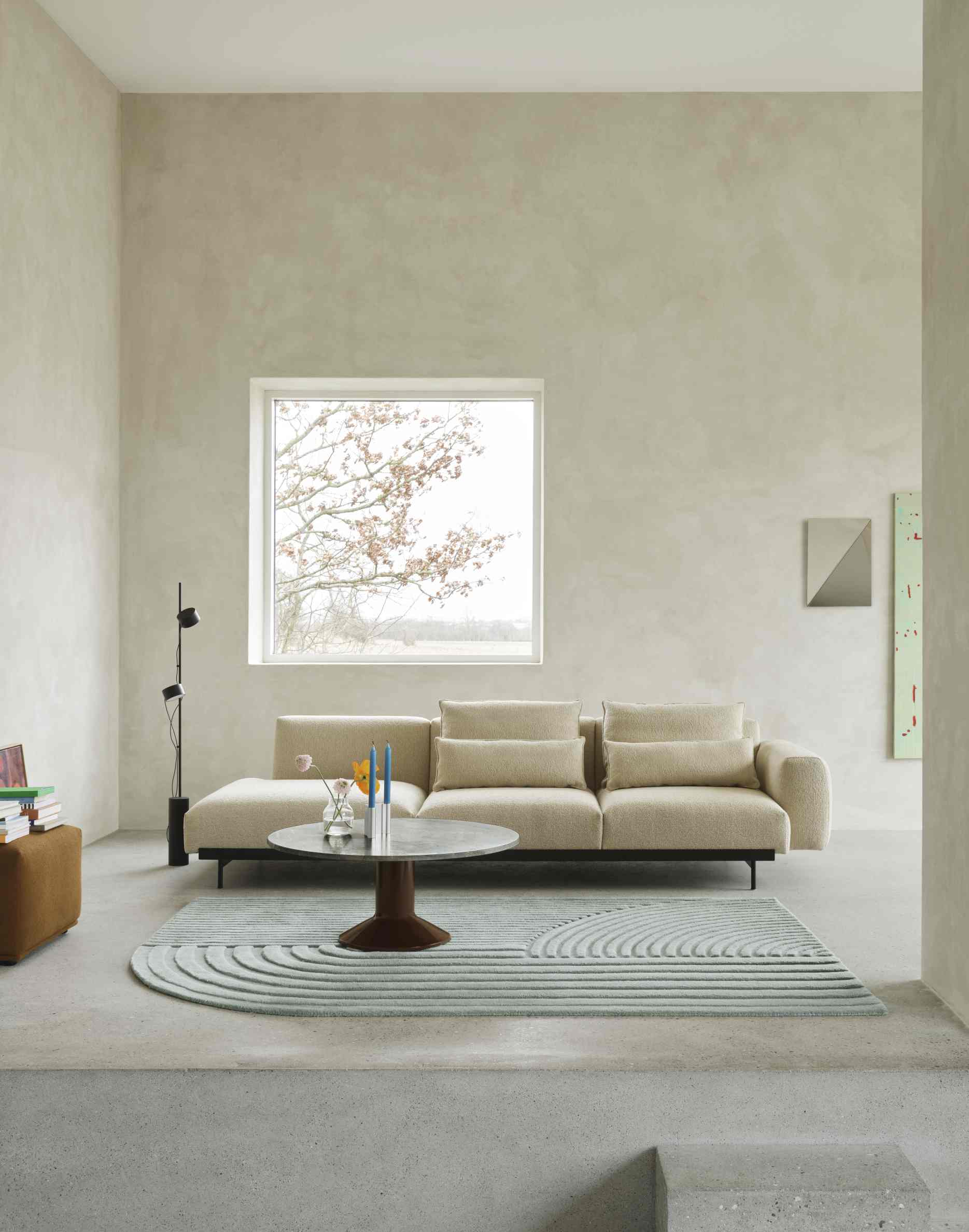 Wohnzimmer mit beigem Sofa, Teppich und Muuto MIDST Coffee Table Couchtisch mit runder Tischplatte.
