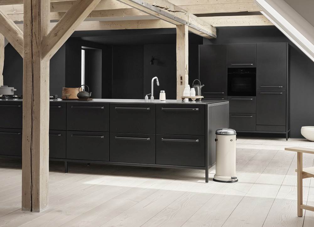 Beiger Vipp Treteimer 14L in moderner Küche mit schwarzen Schränken und hellem Holzboden.