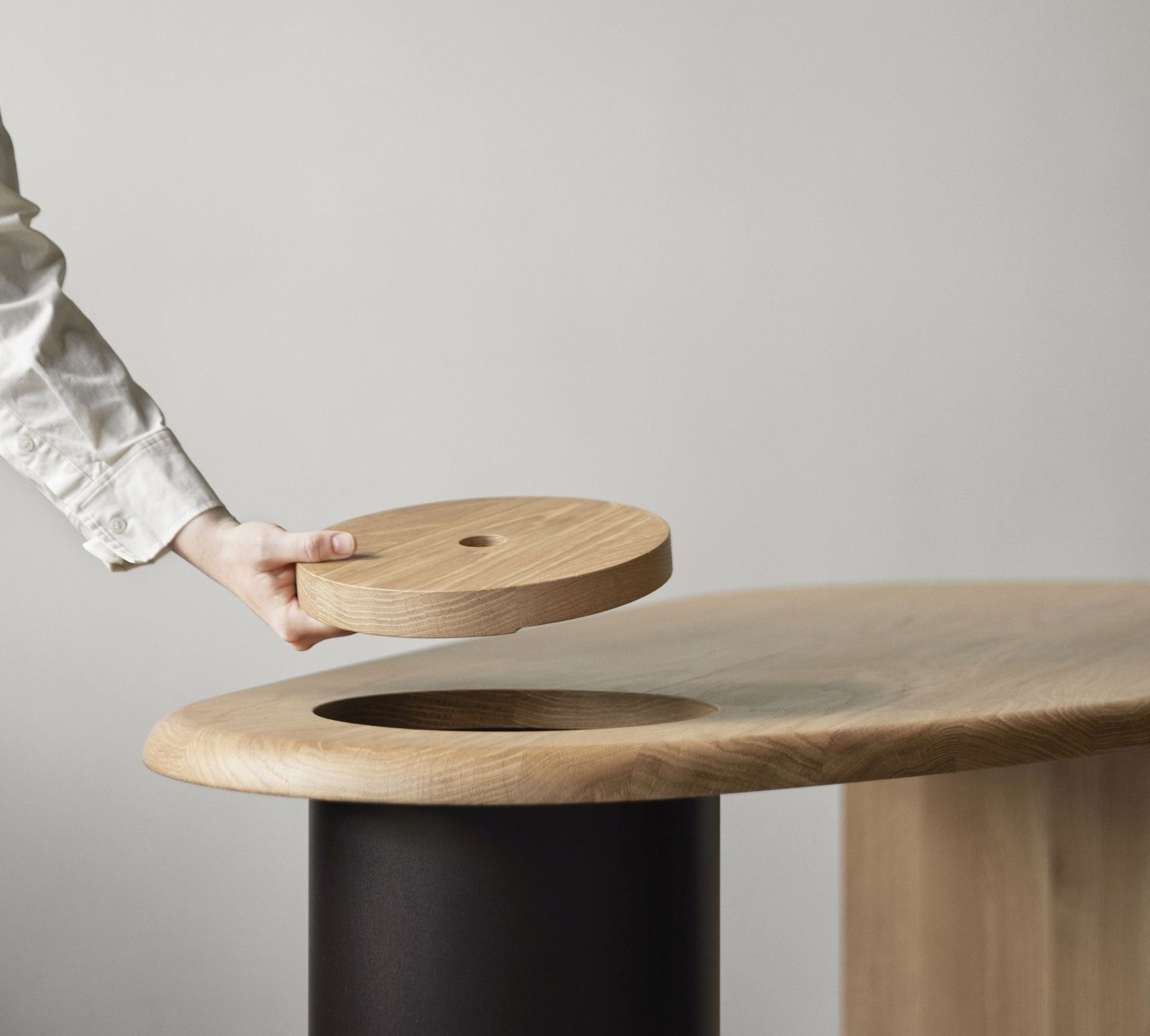 The Eclipse Desk von Audo Copenhagen: Detailaufnahme des Holzschreibtisches mit runder Abdeckung über einer Aussparung.